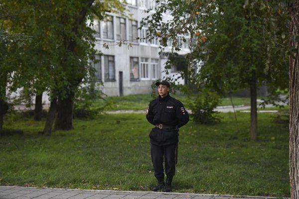 A policeman stands guard near a vocational college in Kerch, on Oct. 18, 2018. (Sergei Demidov/AP)