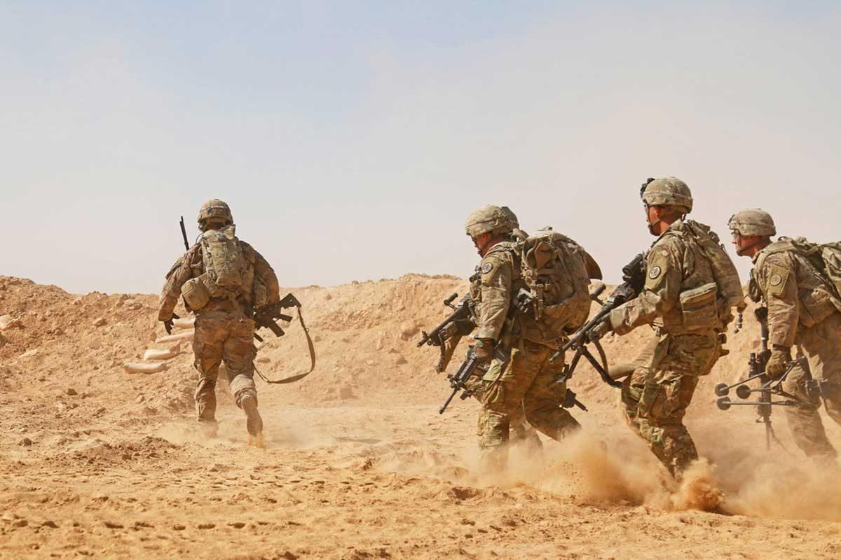 Soldiers assigned to the 3rd Cavalry Regiment and deployed in support of Combined Joint Task Force—Operation Inherent Resolve rush to a berm to establish a hasty fighting position during a live-fire training exercise near Al Asad Air Base, Iraq, Sept. 26, 2018. (U.S. Army National Guard photo by 1st Lt. Leland White)