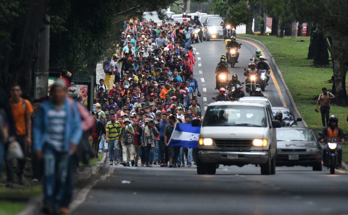 Honduran migrants in a caravan heading to the United States, walk in direction of the border with Mexico as they leave Guatemala City on Oct. 18, 2018. (Orlando Sierra/AFP/Getty Images)