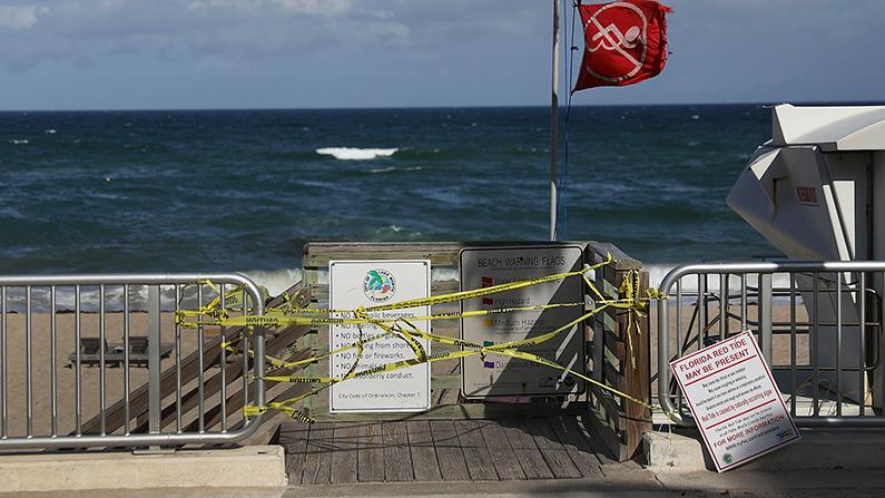 Caution tape closes off an entrance to the beach in Lake Worth, Fla., under a no-swimming flag on Oct. 4, 2018. (Joe Raedle/Getty Images)