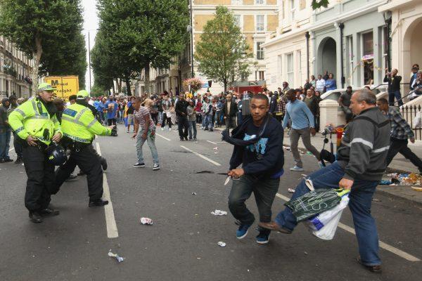 File photo showing a fleeing suspect clutching a knife moments after stabbing a man at the Notting Hill Carnival in London on Aug. 29, 2011. (Oli Scarff/Getty Images)