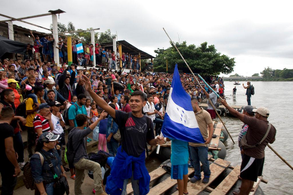 Hundreds of Honduran migrants stand at the shore of the Suchiate river on the border between Guatemala and Mexico, in Tecun Uman, Guatemala, Oct. 18, 2018. (AP Photo)