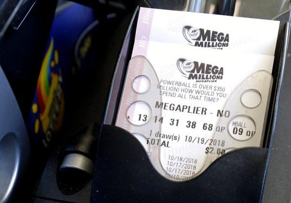 Mega Millions lottery tickets are printed out of a lottery machine at a convenience store Oct. 17, 2018, in Chicago. (AP Photo/Nam Y. Huh)