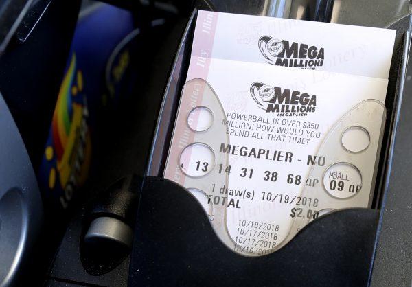 Mega Millions lottery tickets are printed out of a lottery machine at a convenience store in Chicago, on Oct. 17, 2018. (Nam Y. Huh/AP)