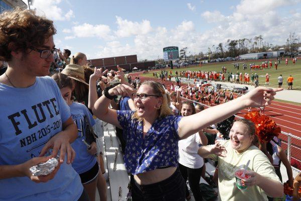 People attend and cheer the football game between Mosley High, which suffered extensive damage from Hurricane Michael, and visiting Pensacola High, in Panama City, Fla., Oct. 20, 2018. (AP Photo/Gerald Herbert)