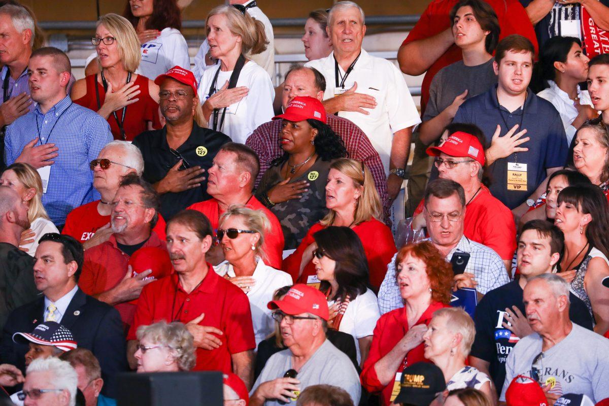 Attendees recite the Pledge of Allegiance at a Make America Great Again rally in Mesa, Arizona, on Oct. 19, 2018. (Charlotte Cuthbertson/The Epoch Times)