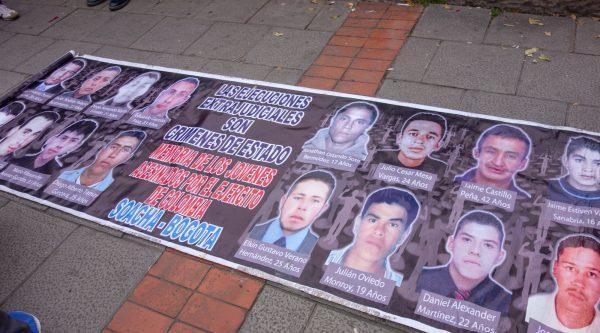 A banner showing the faces of a few of the young men who lost their lives in the “false positives” scandal, in Bogota, Colombia, on Oct. 13, 2018. (Luke Taylor/Special to The Epoch Times)