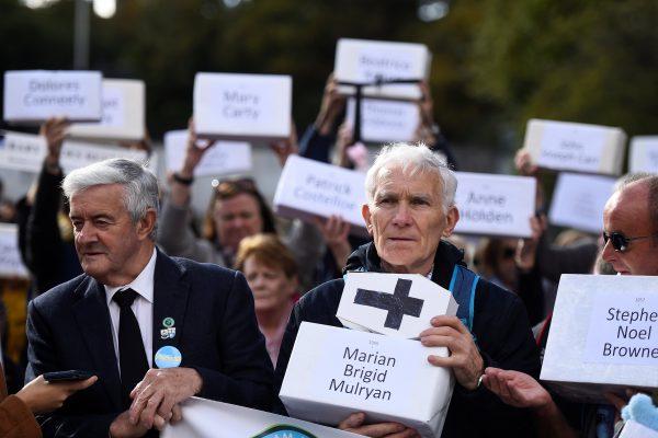 Peter Mulryan holds a funeral box representing a dead child at a procession in remembrance of the bodies of the infants discovered in a septic tank in 2014 at the Tuam Mother and Baby Home, in Dublin, Ireland on Oct. 6, 2018. (Reuters/Clodagh Kilcoyne)