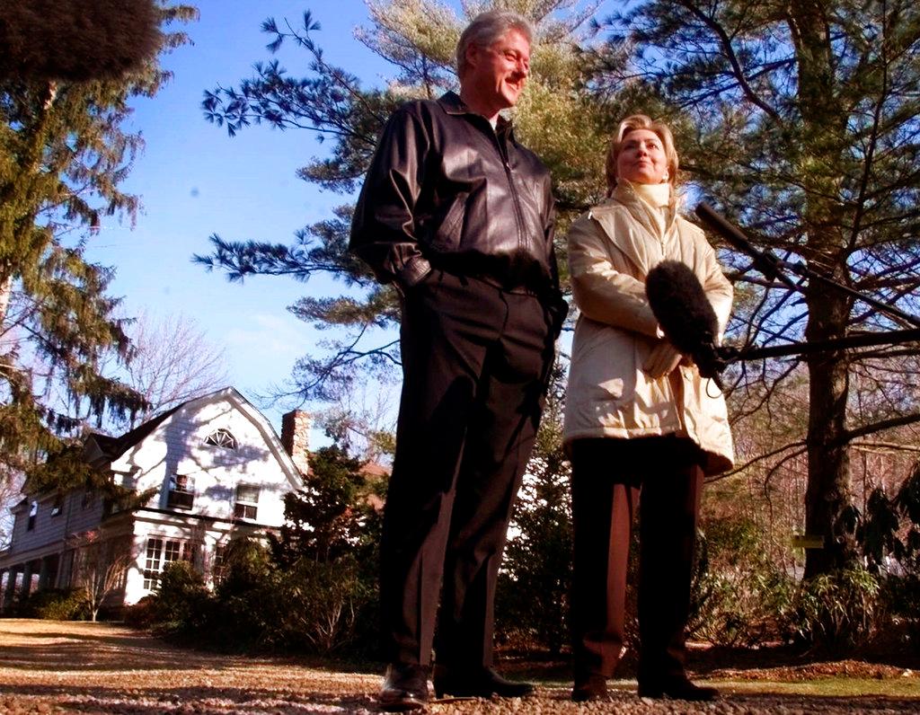 Bill and Hillary Clinton stand in the driveway of their home in Chappaqua, N.Y. on Jan. 6, 2000. (AP Photo, File)