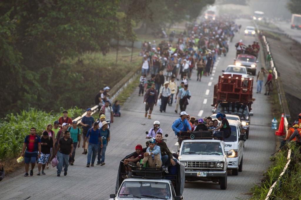 Honduran migrants walking and aboard trucks head in a caravan to the United States, in Huixtla on their way to Mapastepec Chiapas state, Mexico, on October 24, 2018. (PEDRO PARDO/AFP/Getty Images)