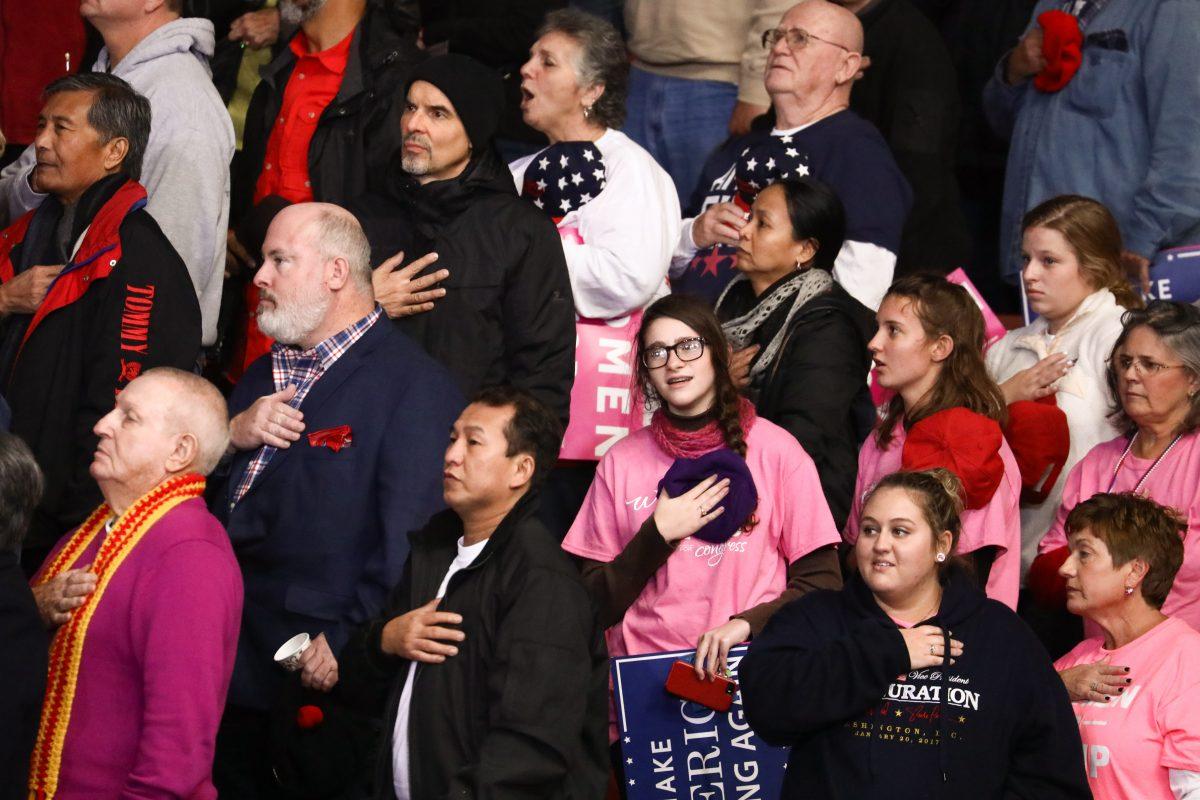 Attendees during the national anthem at a Make America Great Again rally in Charlotte, N.C., on Oct. 26, 2018. (Charlotte Cuthbertson/The Epoch Times)