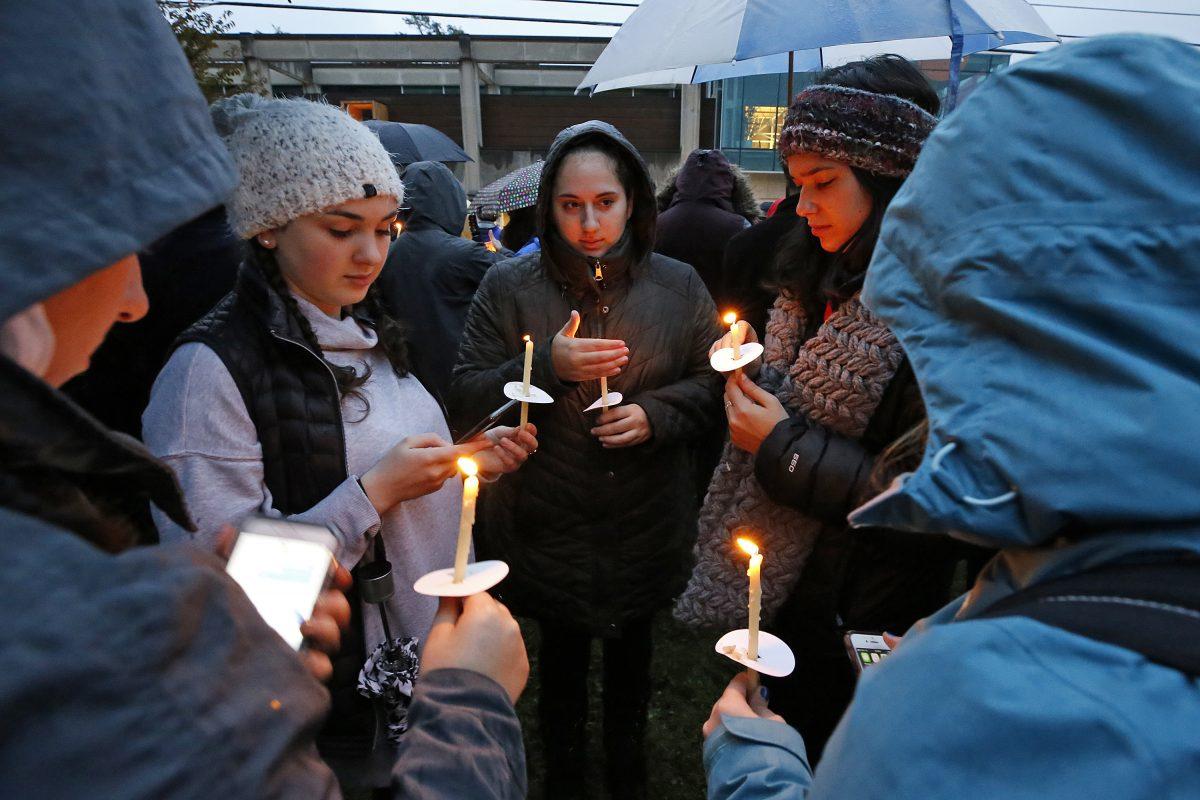 Holding candles, a group of girls waits for the start of a memorial vigil at the intersection of Murray Ave. and Forbes Ave. in the Squirrel Hill section of Pittsburgh, for the victims of the shooting at the Tree of Life Synagogue on Oct. 27, 2018. (Gene J. Puskar/AP)