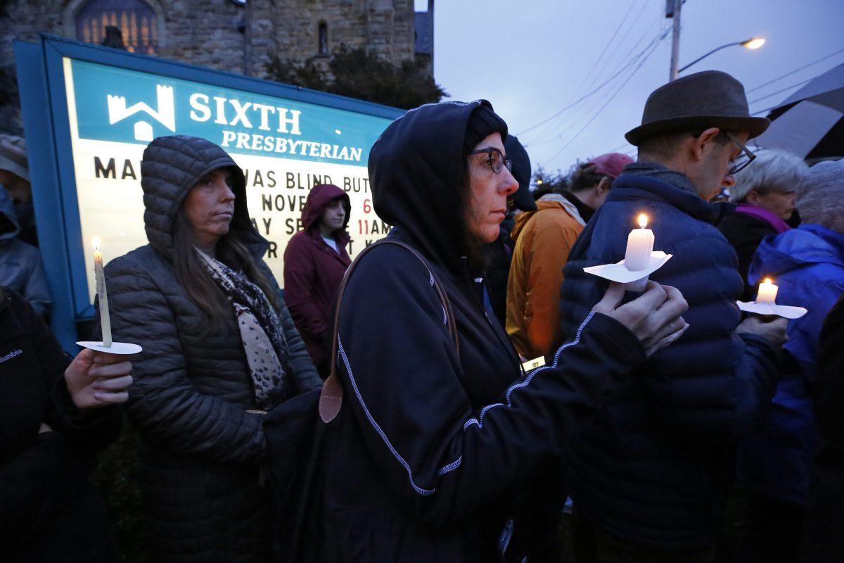 People hold candles on the lawn of the Sixth Presbyterian Church in the Squirrel Hill section of Pittsburgh during a memorial vigil for the victims of the shooting at the Tree of Life Synagogue, on Oct. 27, 2018. (Gene J. Puskar/AP Photo)