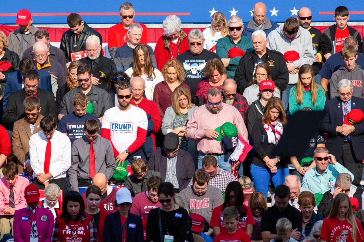 Attendees pray for the victims of the shooting at Pittsburgh at President Donald Trump’s Make America Great Again rally in Murphysboro, Ill., on Oct. 27, 2018. (Hu Chen/The Epoch Times)