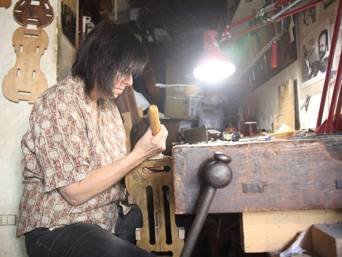Jamie Lazzara makes everything by hand in her violin making workshop. Here she works on a traditional Italian violin form. (Lorraine Ferrier/The Epoch Times)