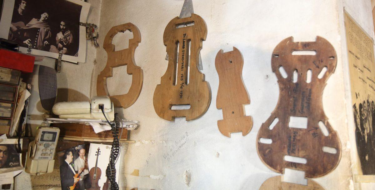 Various violin forms hang on the wall. Second from the left is a 1719 Stradavari, and far to the right, a Guarneri. (Lorraine Ferrier/The Epoch Times)
