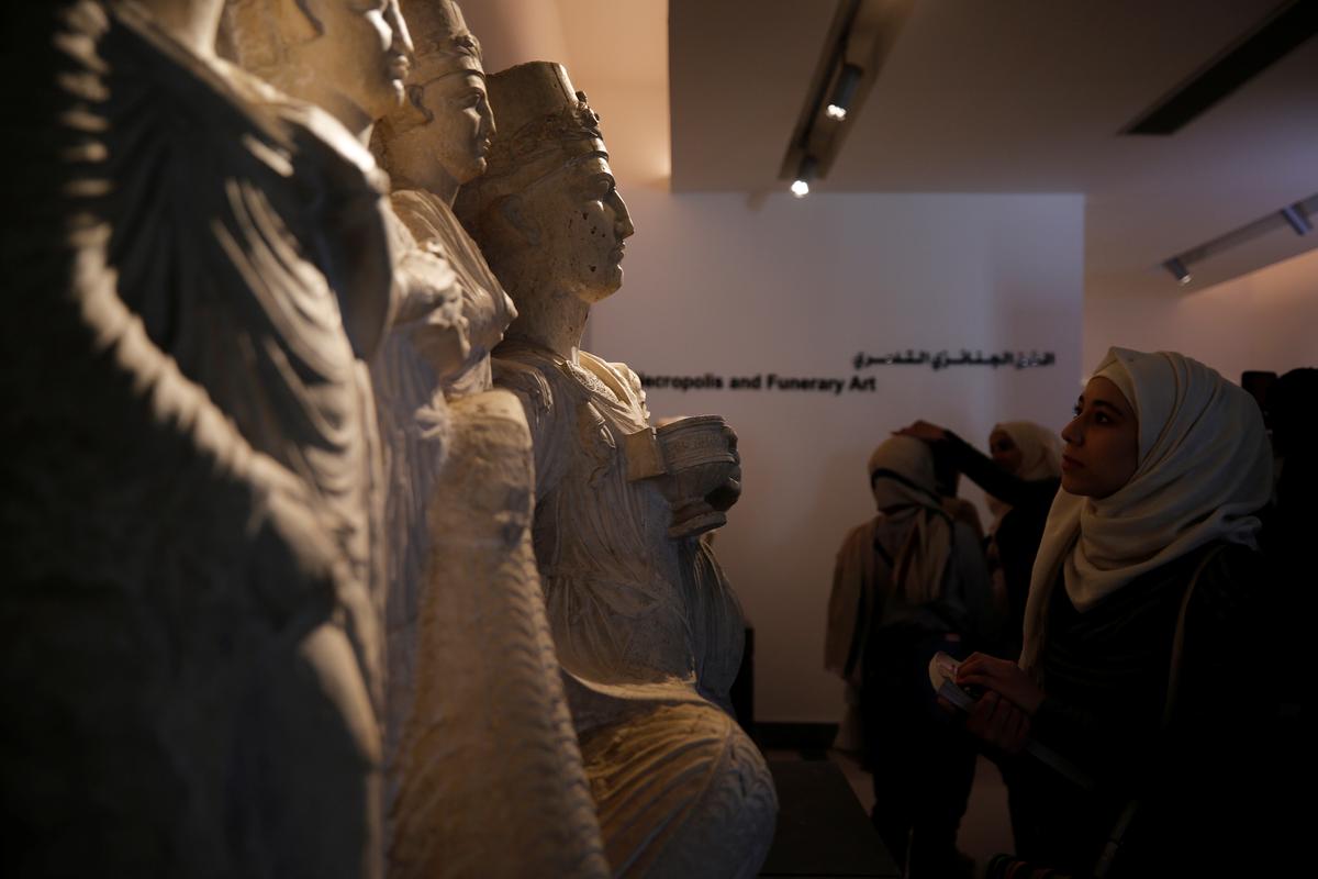 Visitors look at sculptures displayed during the reopening of Syria's National Museum of Damascus, Syria, on Oct. 28, 2018. (Omar Sanadiki/Reuters)