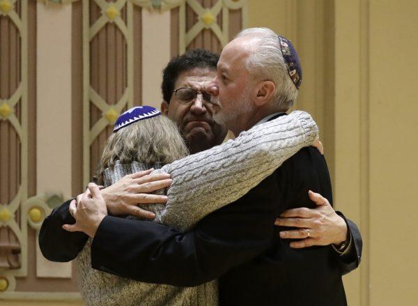 Rabbi Jeffrey Myers, right, of Tree of Life/Or L'Simcha Congregation hugs Rabbi Cheryl Klein, left, of Dor Hadash Congregation and Rabbi Jonathan Perlman during a community gathering held in the aftermath of a deadly shooting at the Tree of Life Synagogue in Pittsburgh, on Oct. 28, 2018. (Matt Rourke/AP)