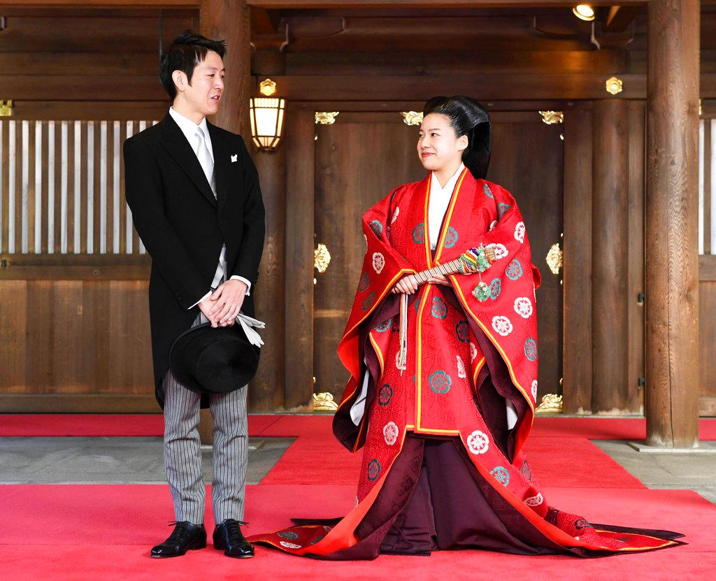 Japanese Princess Ayako, right, dressed in a traditional ceremonial robe, and groom Kei Moriya, left, speak to the reporters after their wedding ceremony at Meiji Shrine in Tokyo, Oct. 29, 2018. (Kyodo News via AP)