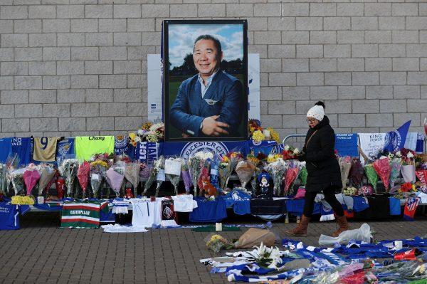 A woman places flowers outside Leicester City's King Power stadium in Leicester, United Kingdom, on Oct 29, 2018. (Reuters/Peter Nicholls)
