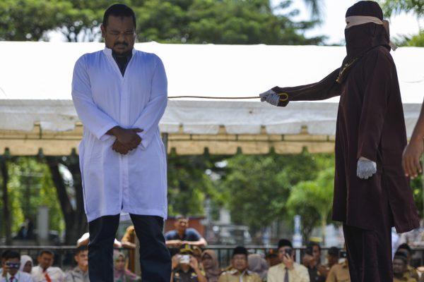 An Indonesian man is caned in public after being caught in close proximity with his girlfriend in Banda Aceh, on Oct. 29, 2018. (Chaideer Mahyuddin/AFP/Getty Images)