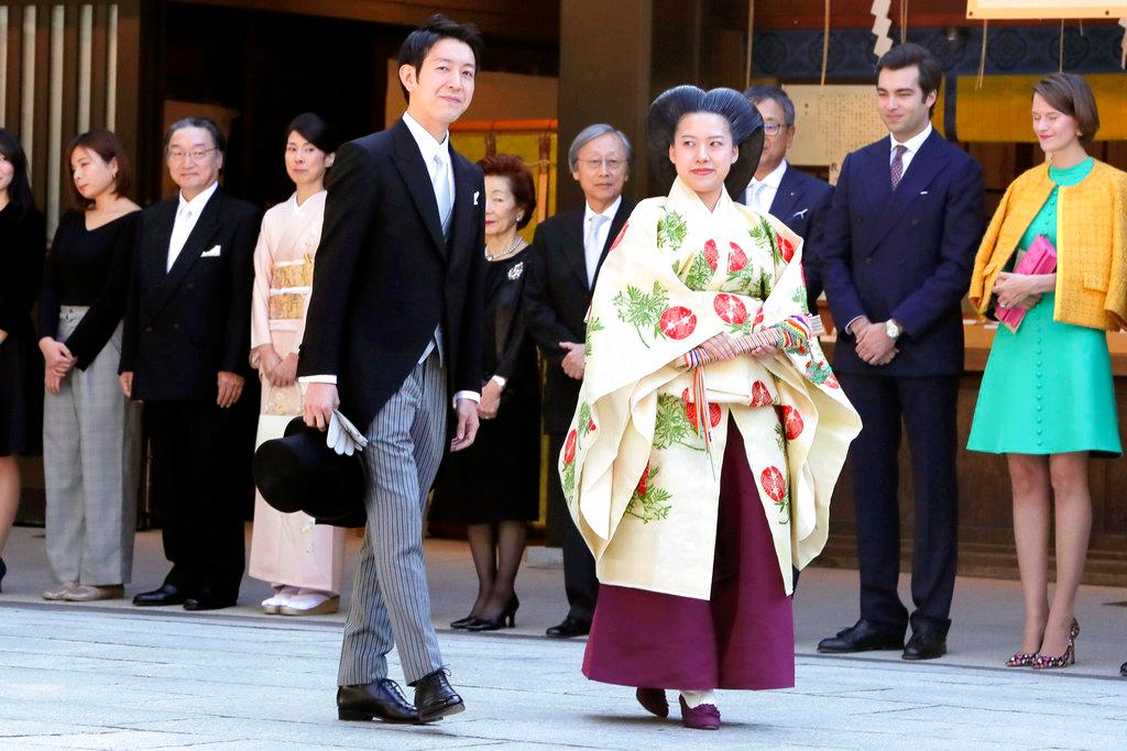 Japanese Princess Ayako, center right, dressed in traditional ceremonial robe, and groom Kei Moriya, center left, arrive at Meiji Shrine for their wedding ceremony in Tokyo, Oct. 29, 2018. (Kyodo News via AP)