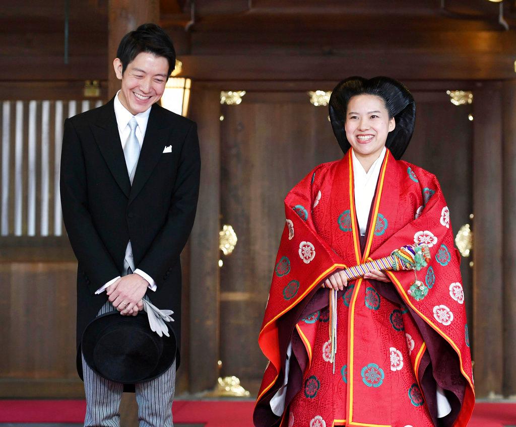 Japanese Princess Ayako, right, dressed in traditional ceremonial robe, and groom Kei Moriya, left, speak to the reporters after their wedding ceremony at Meiji Shrine in Tokyo on Oct. 29, 2018. (Kyodo News via AP)