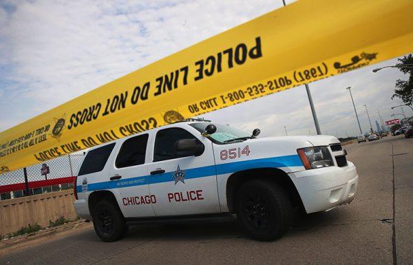 Police investigate the murder of a young man found shot to death in the back seat of a bullet-riddled car in Chicago, Illinois on June 30, 2017. (Scott Olson/Getty Images)