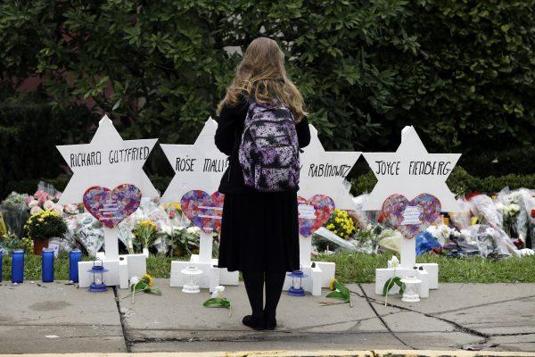 A woman in front of the Stars of David with the names of those killed in a deadly shooting at the Tree of Life synagogue, in Pittsburgh, Oct. 29, 2018. (Matt Rourke/AP Photo)
