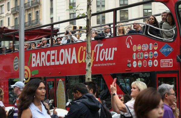 Tourists ride a double-decker bus on Passeig de Gracia avenue in Barcelona, Spain, in this file photo. (Sean Gallup/Getty Images)