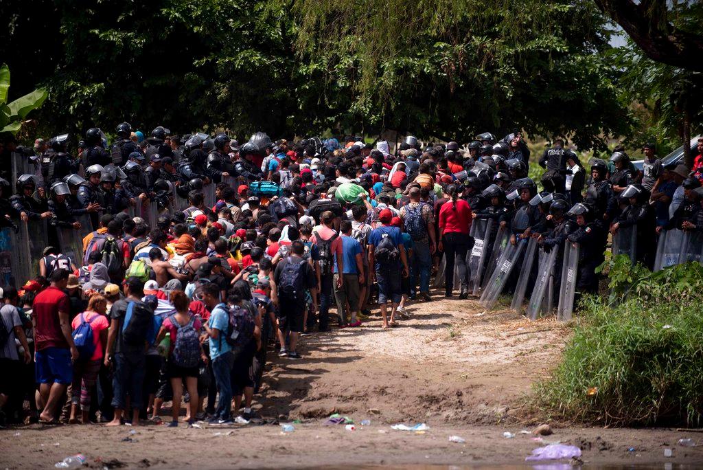The second migrant caravan got violent at the Guatemala-Mexico border on Oct. 29, 2018, as a third migrant caravan reached Guatemala after starting in El Salvador. (AP Photo/Santiago Billy)