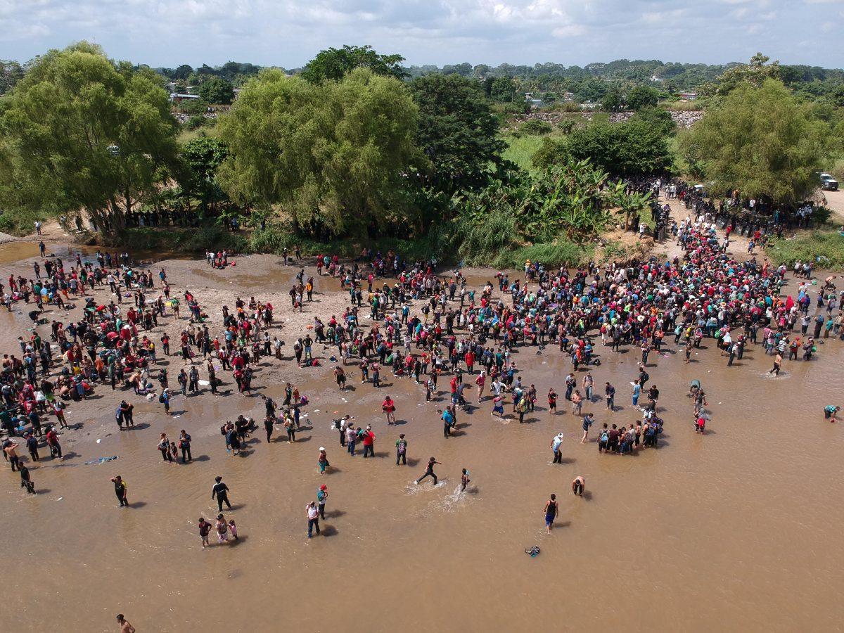 Migrants reaching Mexico after crossing the Suchiate River from Tecun Uman in Guatemala to Ciudad Hidalgo in Mexico on Oct. 29, 2018, a day after a security fence on the international bridge was reinforced to prevent them from passing through. (Carlos Alonzo/AFP/Getty Images)