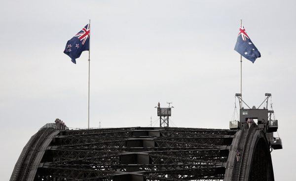 The Australian flag (R) and the New Zealand flag fly on the Sydney Harbour Bridge to commemorate Australia New Zealand Army Corps Day on April 25, 2005. (Ian Waldie/Getty Images)