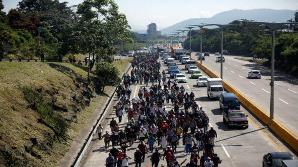 People walk in a caravan of migrants departing from El Salvador en route to the United States, in San Salvador, El Salvador, on Oct. 31, 2018. (Jose Cabezas/Reuters)