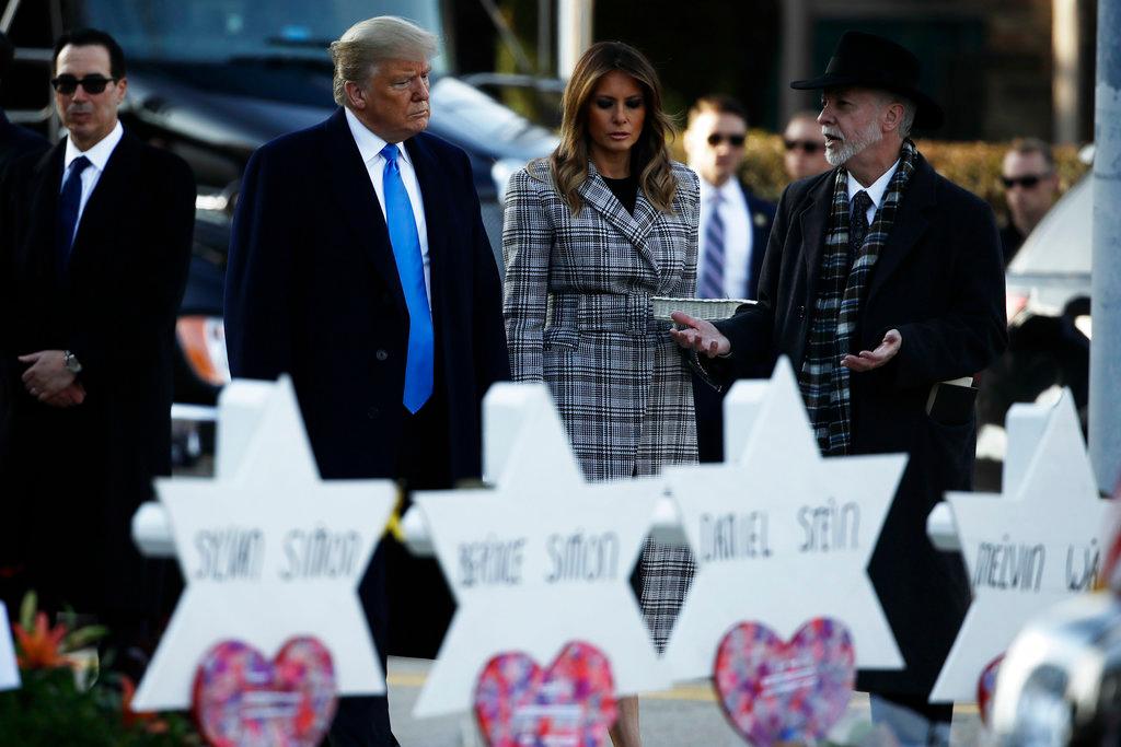 President Donald Trump and First Lady Melania Trump visit a memorial outside Pittsburgh's Tree of Life Synagogue in Pittsburgh on Oct. 30, 2018. Jeffrey Myers, Tree of Life rabbi, is on the right. (AP Photo/Matt Rourke)
