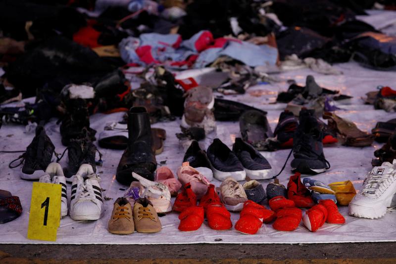 Recovered shoes believed to be from the crashed Lion Air flight JT610 are laid out at Tanjung Priok port in Jakarta, Indonesia, Nov. 1, 2018. (Reuters/Edgar Su)