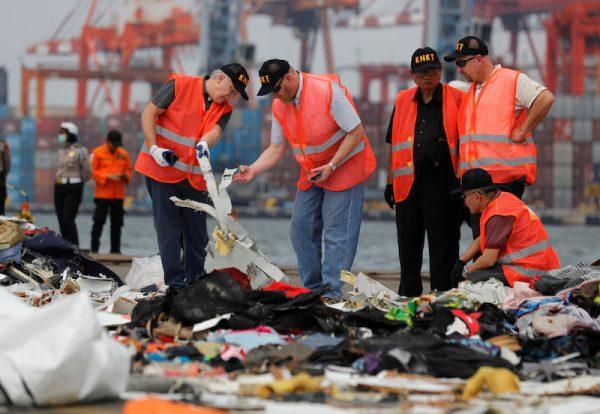 Personnel from National Transportation Safety Board examine debris from Lion Air flight JT610 at Tanjung Priok port in Jakarta, Indonesia, on Nov. 1, 2018. (Reuters/Beawiharta)