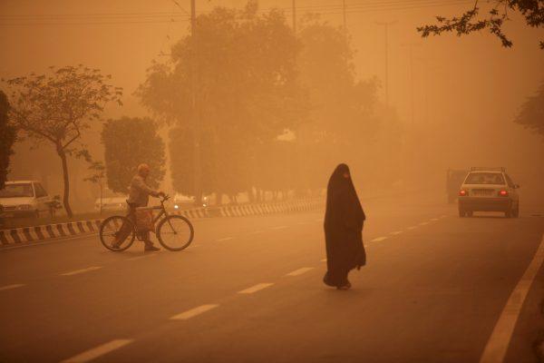Iranians cross a street as a heavy sandstorm hits the city of Ahvaz in the southwestern province of Khuzestan on April 13, 2011. (Mohammad Reza Dehdari/AFP/Getty Images)