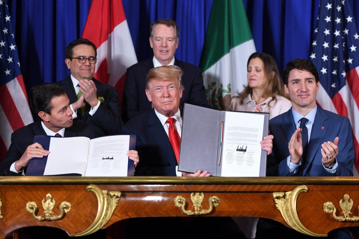 Mexico's President Enrique Pena Nieto (L), U.S. President Donald Trump (C) and Canadian Prime Minister Justin Trudeau, sign a new free trade agreement in Buenos Aires, on the sidelines of the G20 Leaders' Summit on Nov. 30, 2018. (Saul Loeb/AFP/Getty Images)