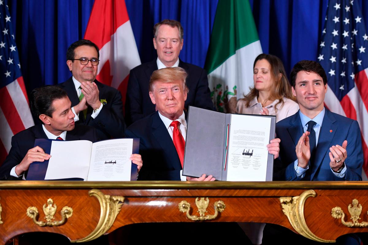 Mexico's former President Enrique Pena Nieto (L), President Donald Trump (C), and Canadian Prime Minister Justin Trudeau, sign a new free trade agreement in Buenos Aires, on the sidelines of the G20 Leaders' Summit on Nov. 30, 2018. (Saul Loeb/AFP/Getty Images)