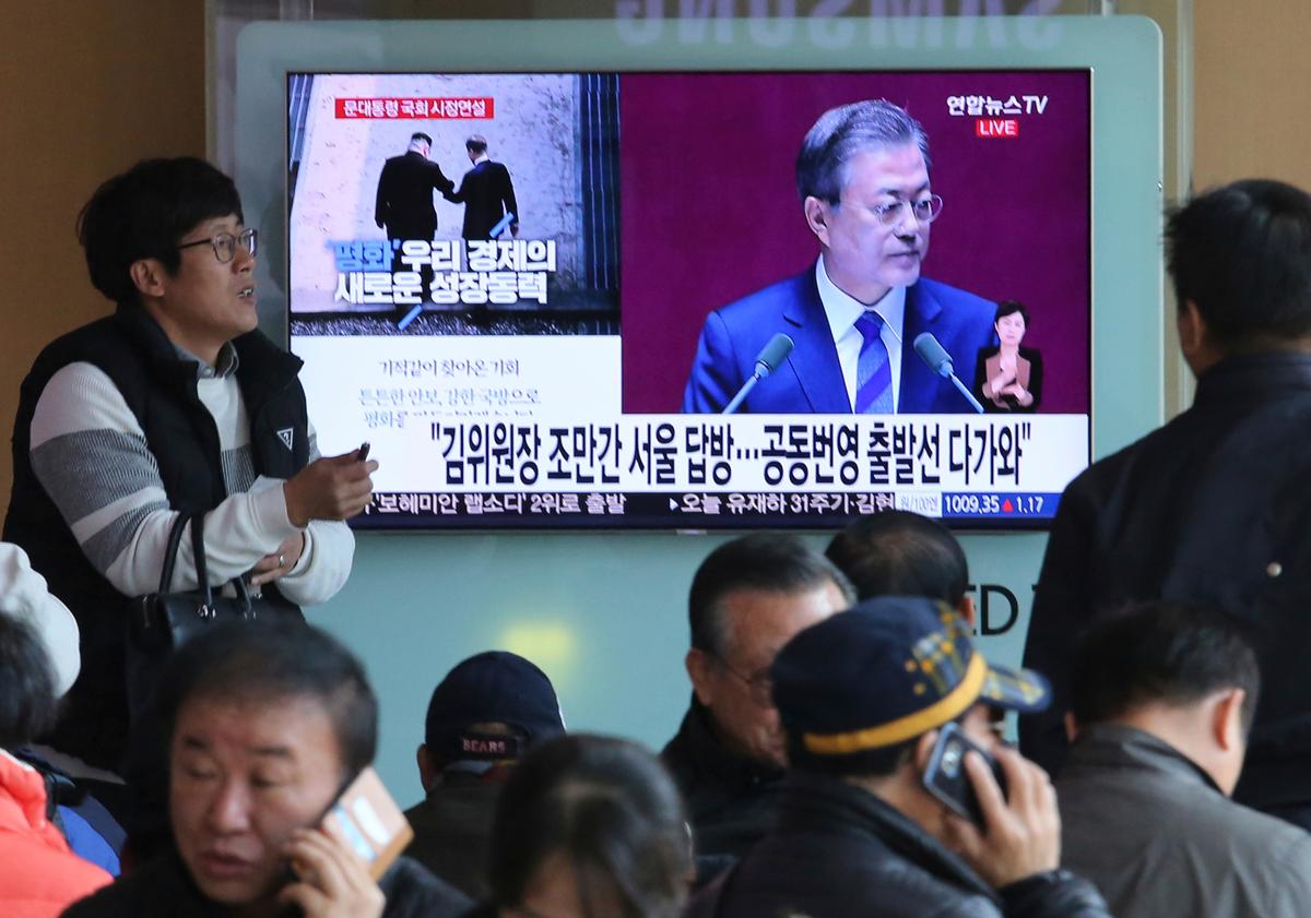 People watch a TV screen showing the live broadcast of South Korean President Moon Jae-in's speech on the economy given before the parliament, at the Seoul Railway Station in Seoul, South Korea, on Nov. 1, 2018. (Ahn Young-joon/AP)