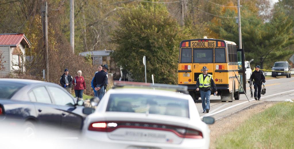 Emergency personnel responded to a scene of a collision that killed three children crossing SR 25 as they were boarding their school bus north of Rochester, Indiana, on Oct. 30, 2018. (Santiago Flores/South Bend Tribune via AP)