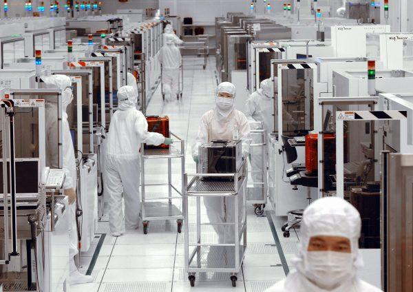 Engineers of United Microelectronics Corp (UMC) push trollies at the 12-inch UMC wafer factory in Tainan Science Park, Taiwan, on April 28 2006. (Sam Yeh/AFP/Getty Images)