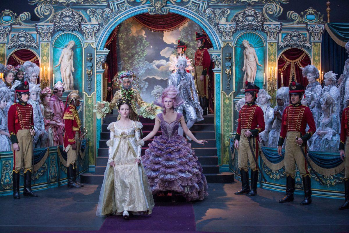 Central figures: Clara (Mackenzie Foy, L), Sugar Plum (Keira Knightley), and behind them, Hawthorne (Eugenio Derbez, L), and Shiver (Richard E. Grant) in “The Nutcracker and the Four Realms.” (Walt Disney Studio Motion Pictures)