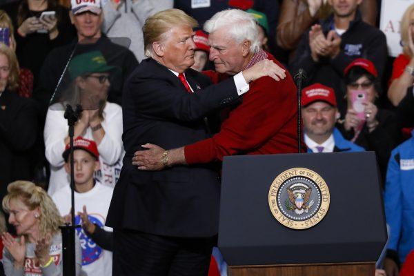 President Donald Trump embraces former Indiana University basketball coach Bobby Knight during a campaign rally in Indianapolis, on Nov. 2, 2018. (Aaron P. Bernstein/Getty Images)