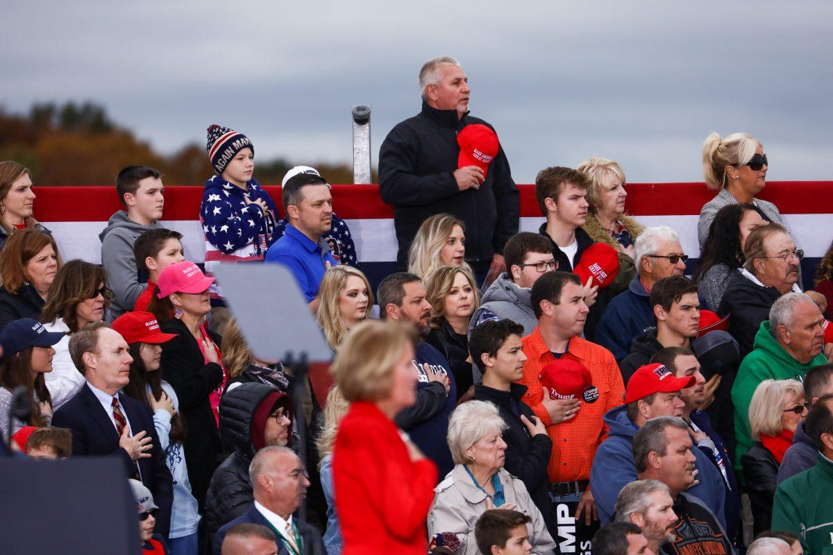 Attendees recite the Pledge of Allegiance at a Make America Great Again rally in Huntington, W.Va., on Nov. 2, 2018. (Charlotte Cuthbertson/The Epoch Times)