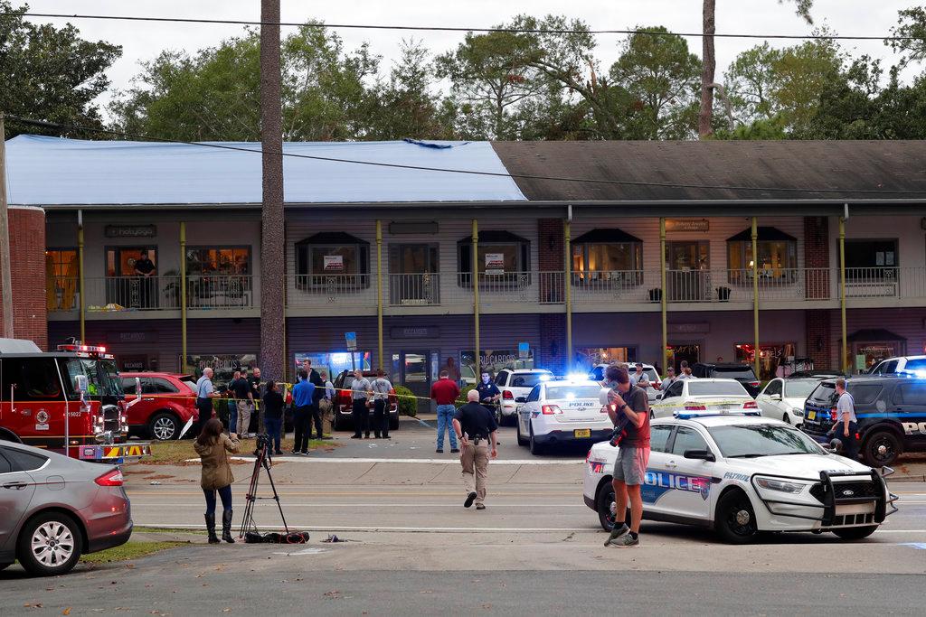 Police investigators work the scene of a shooting in Tallahassee, Fla. on Nov. 2, 2018. A shooter killed one person and critically wounded four others at a yoga studio in Florida's capital before killing himself Friday, officials said. (Tori Schneider/Tallahassee Democrat via AP)