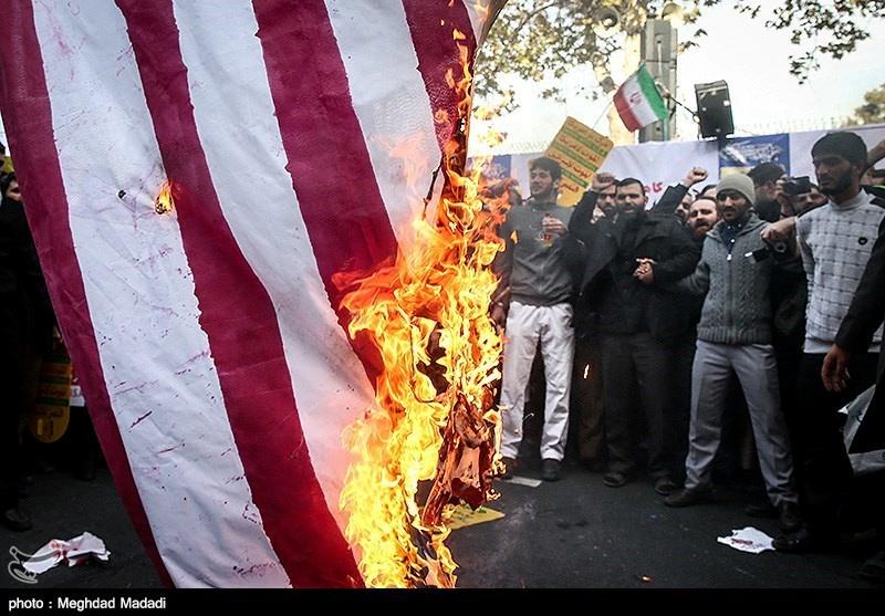 Iranian people burn the U.S. flag as they mark the anniversary of the seizure of the U.S. Embassy, in Tehran, Iran, Nov. 4, 2018. (Tasnim News Agency/Handout via Reuters)