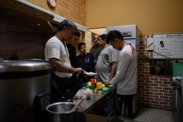Yemeni asylum seekers prepare lunch at the Olle Tourist Hotel in Jeju, South Korea, on July 4, 2018. (Ed Jones/AFP/Getty Images)