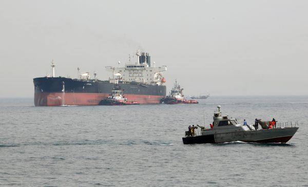 An Iranian military speedboat patrols the waters as a tanker prepares to dock at the oil facility in Iran’s Kharg Island, on the shore of the Persian Gulf, on March 12, 2017. (Atta Kenare/AFP/Getty Images)